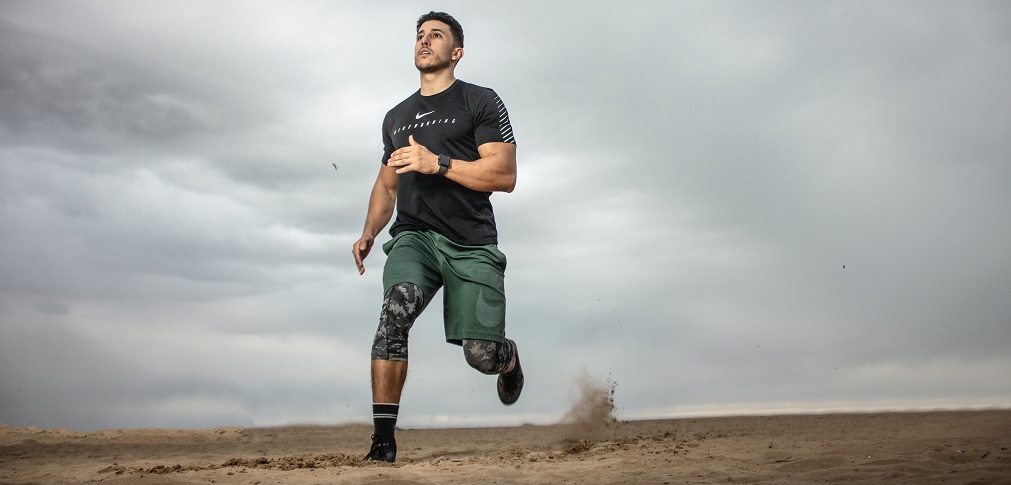 a man running on the soft sand of the beach