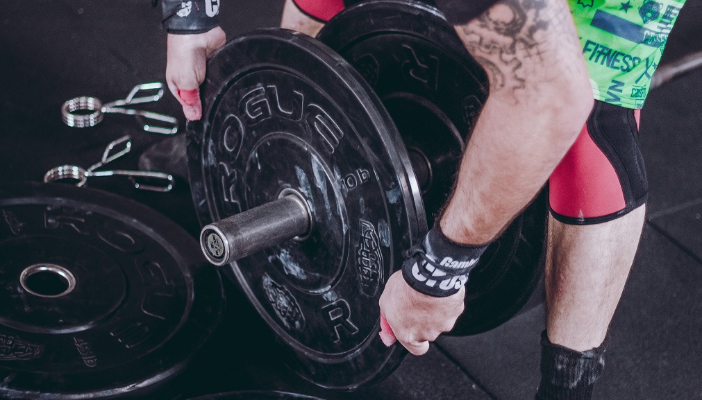 a man moving weight plates