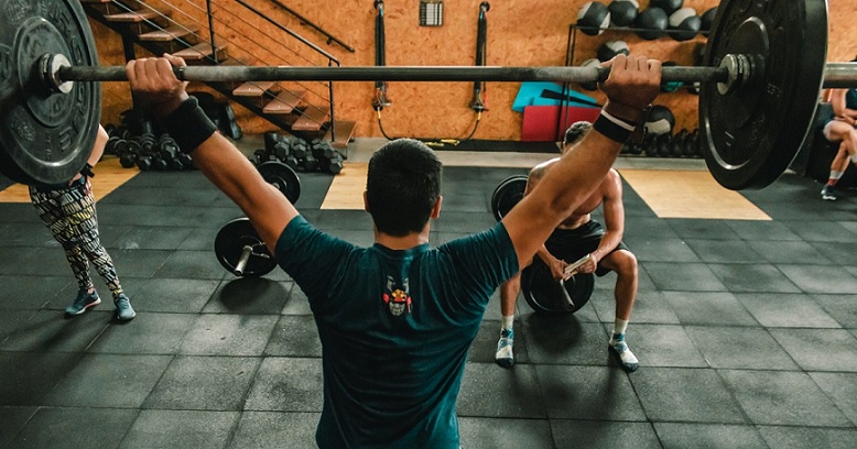 a man lifting a barbell.